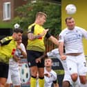 Will Smith beats visiting striker Matt Rhead to a header during Harrogate Town's  play-off semi-final showdown with Boreham Wood. Pictures: Matt Kirkham