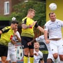 Will Smith beats visiting striker Matt Rhead to a header during Harrogate Town's  play-off semi-final showdown with Boreham Wood. Pictures: Matt Kirkham