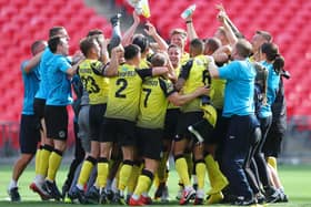 Harrogate Town players celebrate after the final whistle having beaten Notts County 3-1 and securing a place in the Football League for the first time in their history. Picture: Getty Images