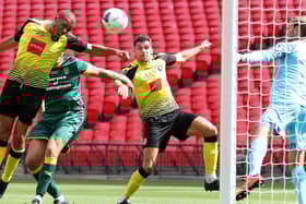 Connor Hall, second right, prepares to pounce to net Harrogate Town's second goal against Notts County. Pictures: Getty Images