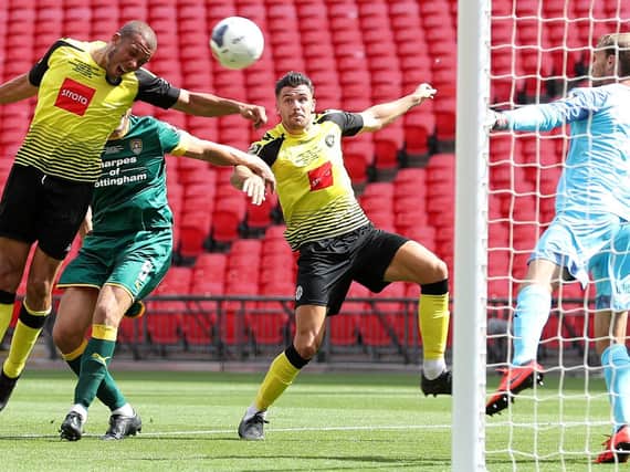 Connor Hall, second right, prepares to pounce to net Harrogate Town's second goal against Notts County. Pictures: Getty Images