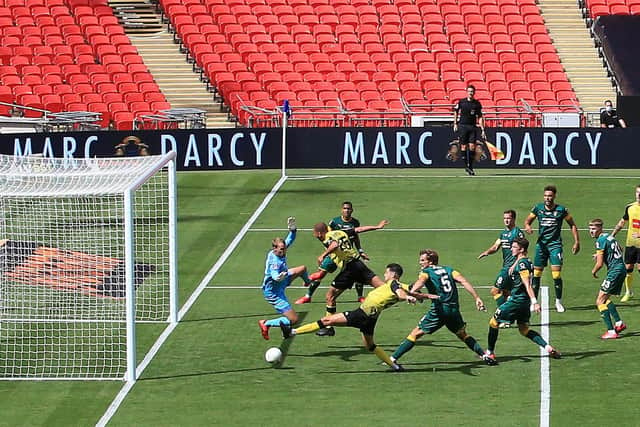 Connor Hall stretches to send the ball past County goalkeeper Sam Slocombe and make it 2-0.