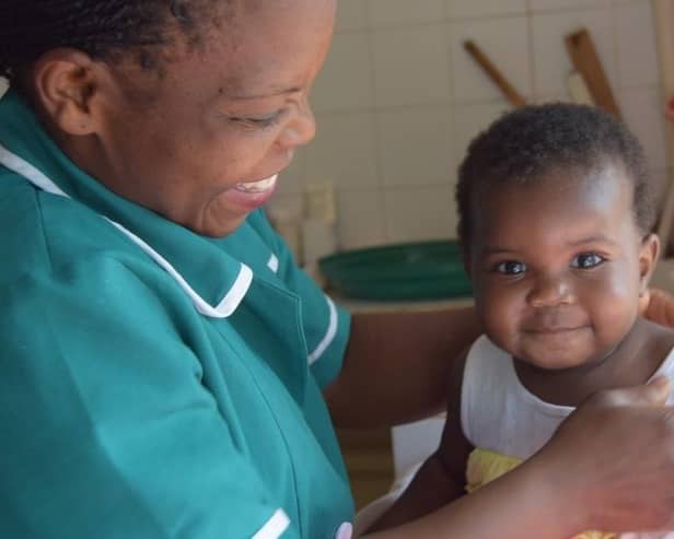 Harrogate charity's plea - An Open Arms staff member Eunice looks after little girl Tamala in Malawi.