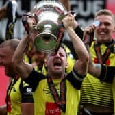 Josh Falkingham, Harrogate captain, lifts the National League Play-off trophy