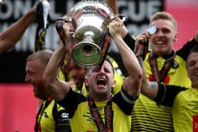 Josh Falkingham, Harrogate captain, lifts the National League Play-off trophy