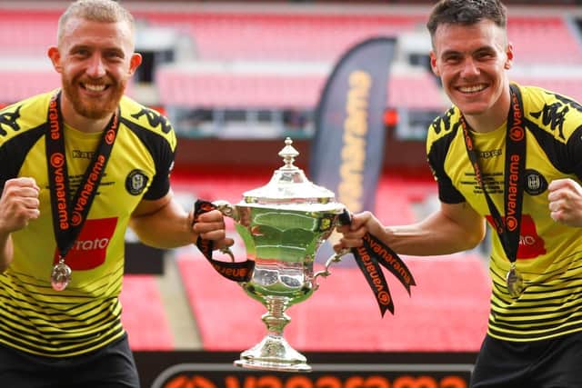George Thomson, left, and Ryan Fallowfield with the National League play-off final winners' trophy at Wembley Stadium. Both men have this week agreed new deals with Harrogate Town