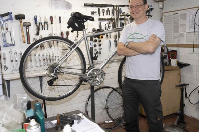 John Rowe with one of the bikes being repaired