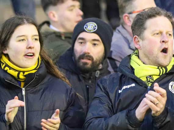 Harrogate Town supporters Dave Worton, right, and his daughter Molly cheer on their team during February's FA Trophy quarter-final win at AFC Fylde. Pictures: Matt Kirkham