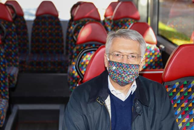 Harrogate and Knaresborough MP Andrew Jones wears one of the colourful face coverings sold by Transdev, with proceeds supporting NHS Charities Together.