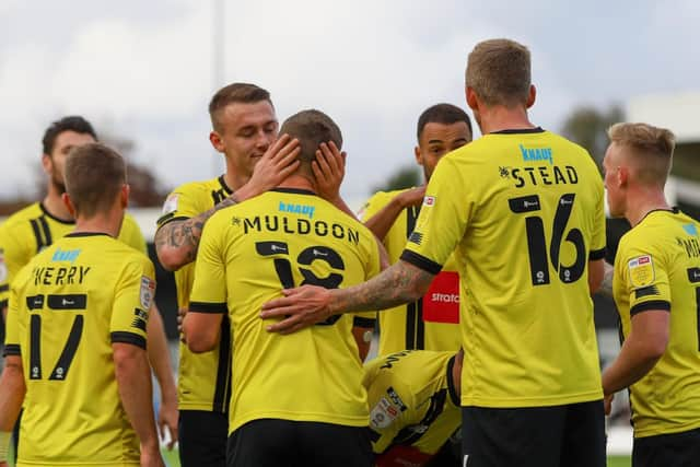 The Harrogate players celebrate Jack Muldoon's 22nd-minute strike.