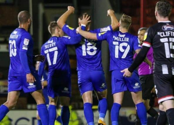 The Harrogate player celebrate at Blundell Park.