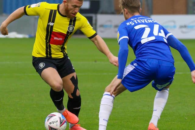 George Thomson looks for a way past Colchester's Ben Stevenson.