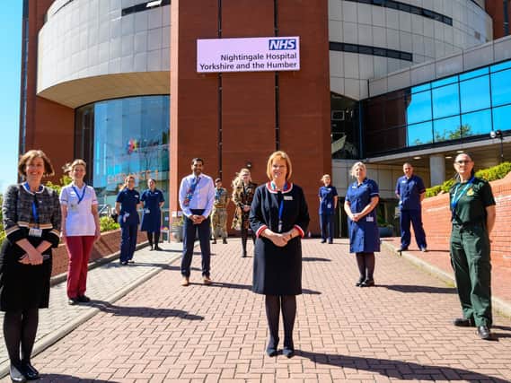Staff outside Harrogate's NHS Nightingale Hospital at Harrogate Convention Centre - The NHS Nightingale hospitals have be asked to get ready to accept patients.