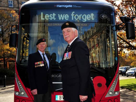 Royal British Legion Knaresborough branch Chairman Alan Pitchfork (left) and Standard Bearer Paul Darley, with one of the Harrogate Bus Company’s buses displaying its own poppy to support the Legion’s annual Poppy Appeal