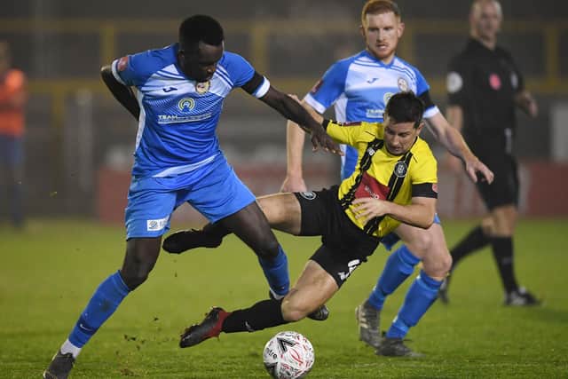 Town skipper Josh Falkingham is floored by Skelmersdale's Mini Adegbenro.