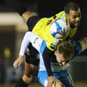 Harrogate Town defender Warren Burrell beats Hull City's James Scott to a header. Pictures: Matt Kirkham