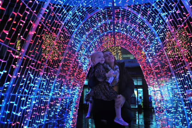 Harrogate Christmas lights switch-on - Rachel Hodgson and her daughter Violet inside the light installation outside the Victoria Shopping Centre. (Picture Gerard Binks)