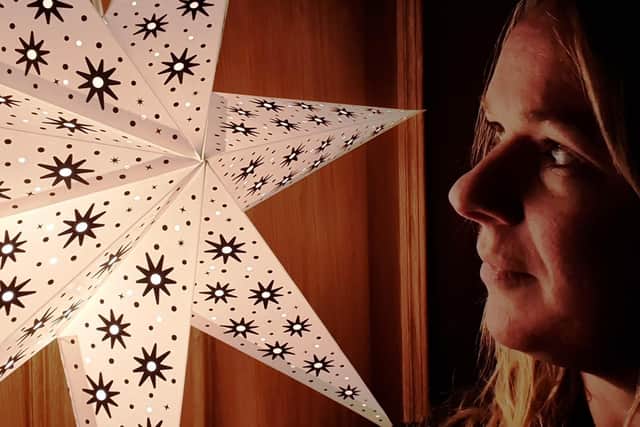 Lizzie Hughes, Project Development Worker at HELP, with one of the donated paper starlights.
