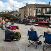 Residents joy singer/songwriter Alaister Griifin performing on a narrow boat in Skipton Canal Basin. Picture: Bruce Rollinson.