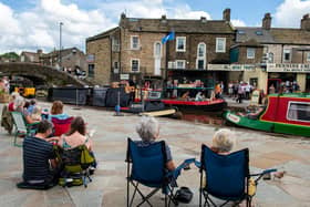 Residents joy singer/songwriter Alaister Griifin performing on a narrow boat in Skipton Canal Basin. Picture: Bruce Rollinson.