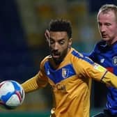 Harrogate Town striker Mark Beck closes in on Mansfield Town's James Perch. Pictures: Matt Kirkham