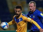 Harrogate Town striker Mark Beck closes in on Mansfield Town's James Perch. Pictures: Matt Kirkham