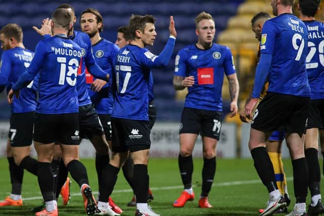 The Harrogate players celebrate after taking the lead through Calvin Miller's 27th-minute strike.