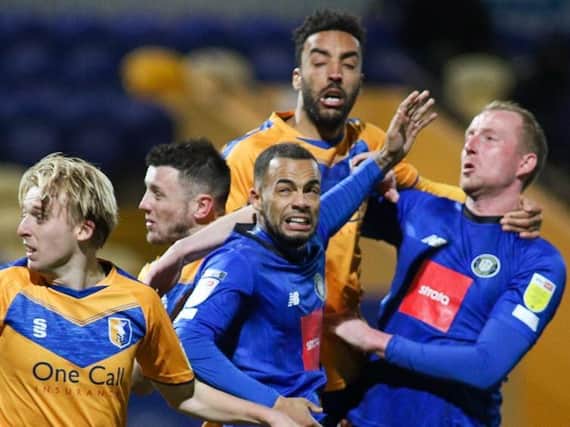 Warren Burrell in the thick of the action during Harrogate Town's win at Mansfield. Pictures: Matt Kirkham