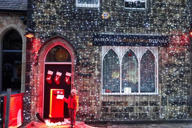 A youngster posting her Christmas wish list to Santa at the new North Pole Post Office at Harrogate International Festivals office sponsored by Harrogate BID.