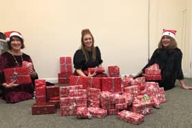 Supporting Older People (SOP) staff wrap presents for distribution to needy clients.