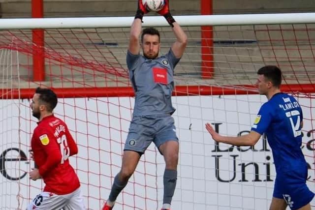 Town stopper James Belshaw shows a safe pair of hands.