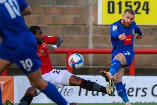 George Thomson takes aim at the Morecambe goal.