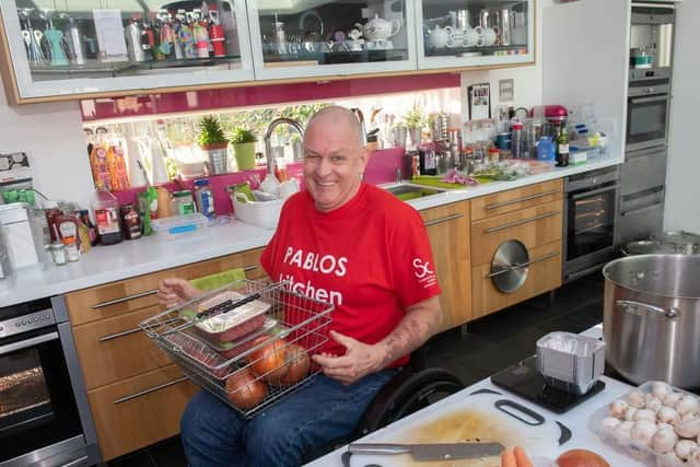 Paul has carried all the food into the kitchen in a basket on his knees.