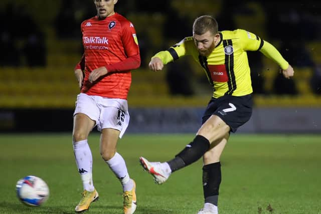 George Thomson lets fly at the Salford City goal.