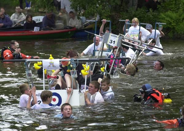 It was the 36 th annual Knaresborough Bed Race on Saturday) and each team had to complete a course around the North Yorkshire town with the final section being the crossing of the River Nidd. Pictured, watched by safety crew,  are  some  of the middle order teams crossing the Nidd.  jun 8 2001.