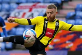 George Thomson fires home Harrogate Town's first goal against Oldham Athletic. Pictures: Matt Kirkham