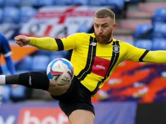 George Thomson fires home Harrogate Town's first goal against Oldham Athletic. Pictures: Matt Kirkham