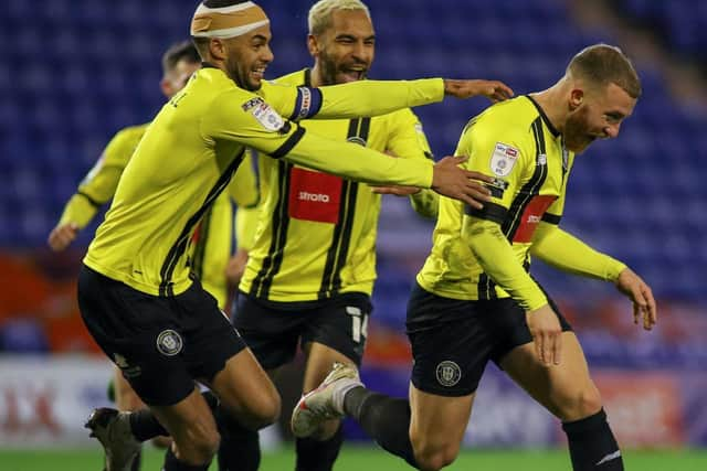 George Thomson, right, leads the celebrations after putting his side 2-1 up at Boundary Park.