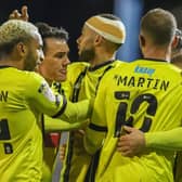 Harrogate Town celebrate after taking a 2-1 lead at Oldham Athletic. Pictures: Matt Kirkham