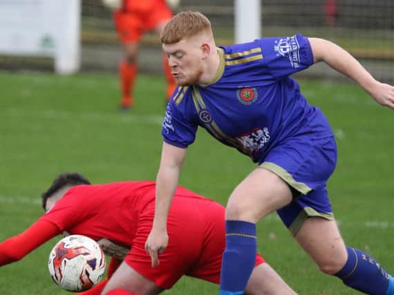 Harrogate Railway left-back Lewis Riley out-muscles a Selby Town attacker during  Boxing Day’s NCEL Division One Yorkshire derby clash. Picture: Craig Dinsdale
