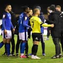Players and staff from both sides confront the match officials following the decision to abandon Harrogate Town's clash with Carlisle United. Pictures: Matt Kirkham