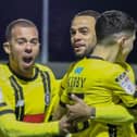 Aaron Martin, left, and Warren Burrell congratulate Connor Kirby, right, after he gave Harrogate Town a first-minute lead against Carlisle United. Tuesday night's game was abandoned soon afterwards. Picture: Matt Kirkham