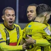 Aaron Martin, left, and Warren Burrell congratulate Connor Kirby, right, after he gave Harrogate Town a first-minute lead against Carlisle United. Tuesday night's game was abandoned soon afterwards. Picture: Matt Kirkham