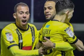 Aaron Martin, left, and Warren Burrell congratulate Connor Kirby, right, after he gave Harrogate Town a first-minute lead against Carlisle United. Tuesday night's game was abandoned soon afterwards. Picture: Matt Kirkham