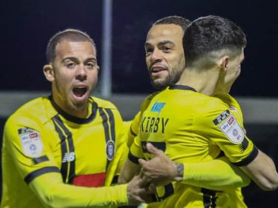 Aaron Martin, left, and Warren Burrell congratulate Connor Kirby, right, after he gave Harrogate Town a first-minute lead against Carlisle United. Tuesday night's game was abandoned soon afterwards. Picture: Matt Kirkham