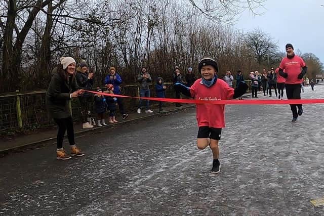 Harry crossing the finish line after his amazing 50km challenge.