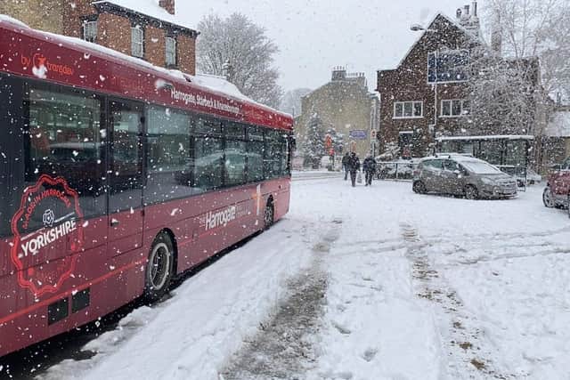 A Harrogate Bus Company vehicle in deep snow at the bus station at Knaresborough Market Place today, Friday.