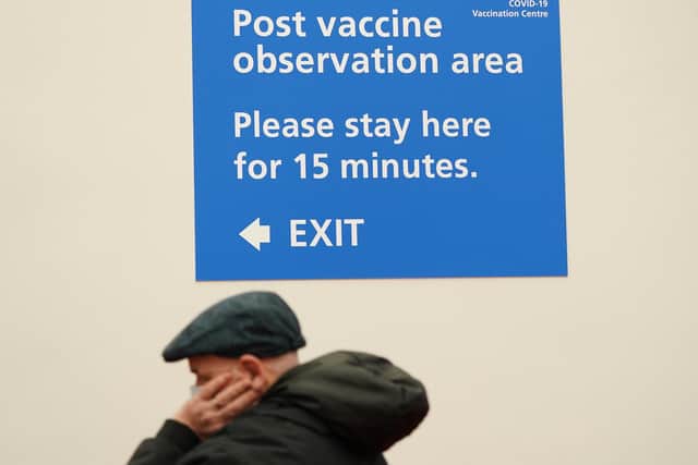 A key worker waits in the post vaccine observation area after receiving the Pfizer BioNTech Covid-19 vaccine at a mass vaccination hub at the Centre For Life in Newcastle. Photo: PA