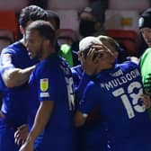 Harrogate Town's players celebrate Jack Muldoon's second-half winner against Exeter City at St James' Park. Pictures: Matt Kirkham