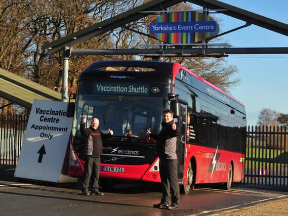 The Harrogate Bus Company bus drivers Stephen Mellor (left) and Dave Stow celebrate the launch of the new free bus service to and from the town's Covid vaccination venue.